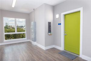 Front door of apartment unity with large floor to ceiling window