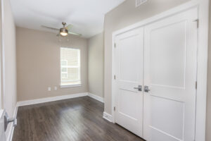 Room with large closet, window and ceiling fan