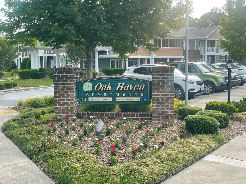 Apartment sign and landscaping