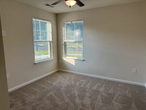 Room with two windows and ceiling fan