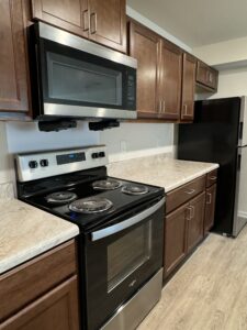 Kitchen with stove, microwave and refrigerator