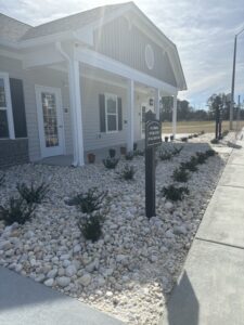 A building with bushes and rock landscaping