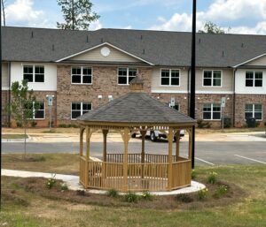 A two story apartment building with a gazebo