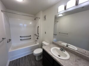 A bathroom with a tub shower combination