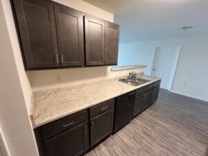 A kitchen with brown cabinets and a sink