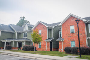 Green and brick two story apartment complex