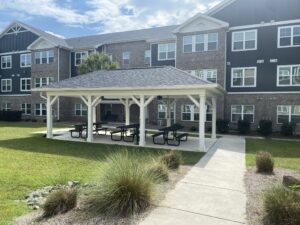 A three story apartment building with a gazebo