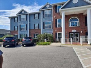 A three story apartment building with blue skies