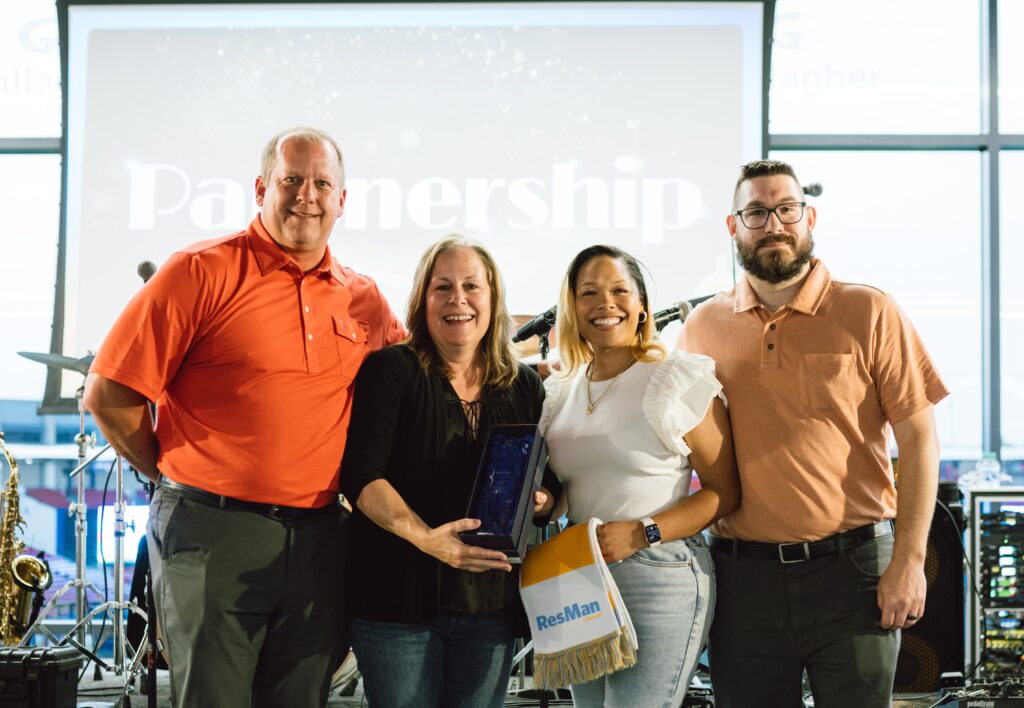 Greg Demski, Tammy Caudle, Hona Moore, and Jeff Stone posing with the Grow Together Trophy