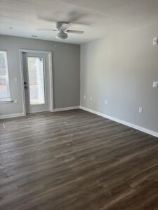 Large Room with ceiling fan and door to outside