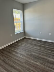 Room with vinyl flooring and window