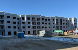 A four story apartment building that is under construction.