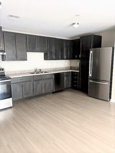 A large kitchen with cabinets and stainless steel appliances