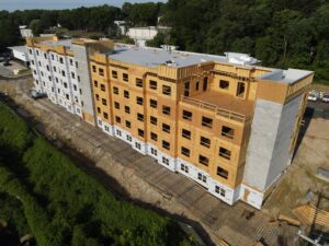 A five story apartment community that is under construction.