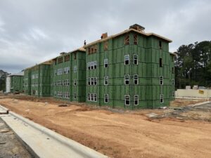 A four story apartment building that is under construction.